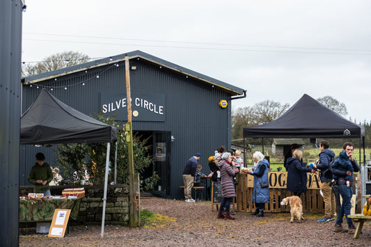 Christmas market stalls outside Silver Circle Distillery